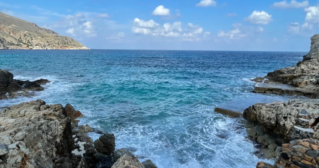 Clear blue water and rocky coastline in Crete Greece