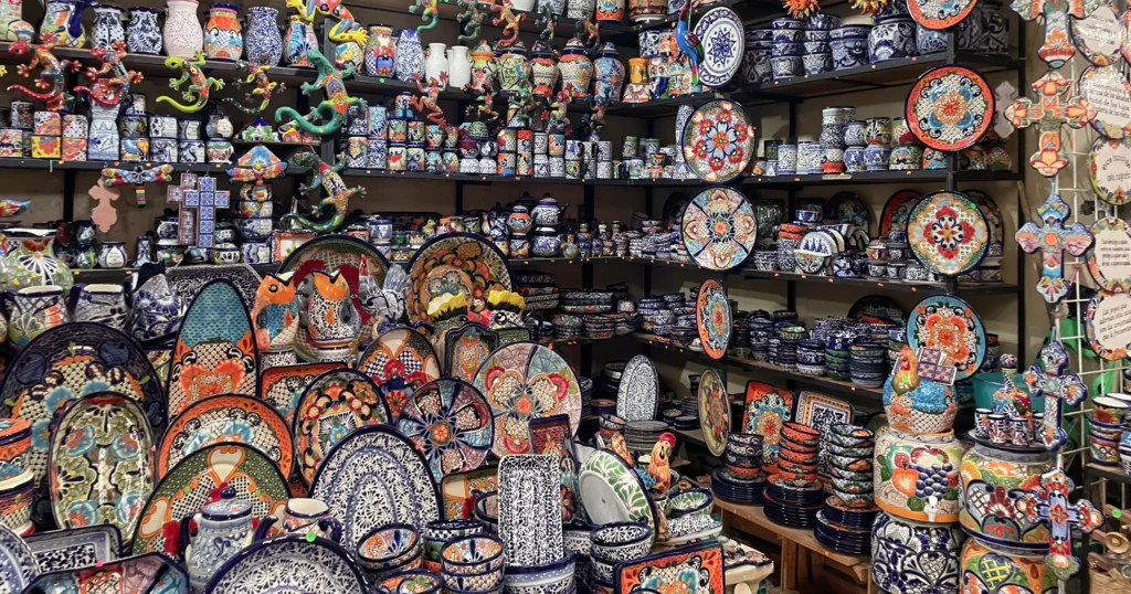 Artisans market stall with shelves of colorful mexican pottery