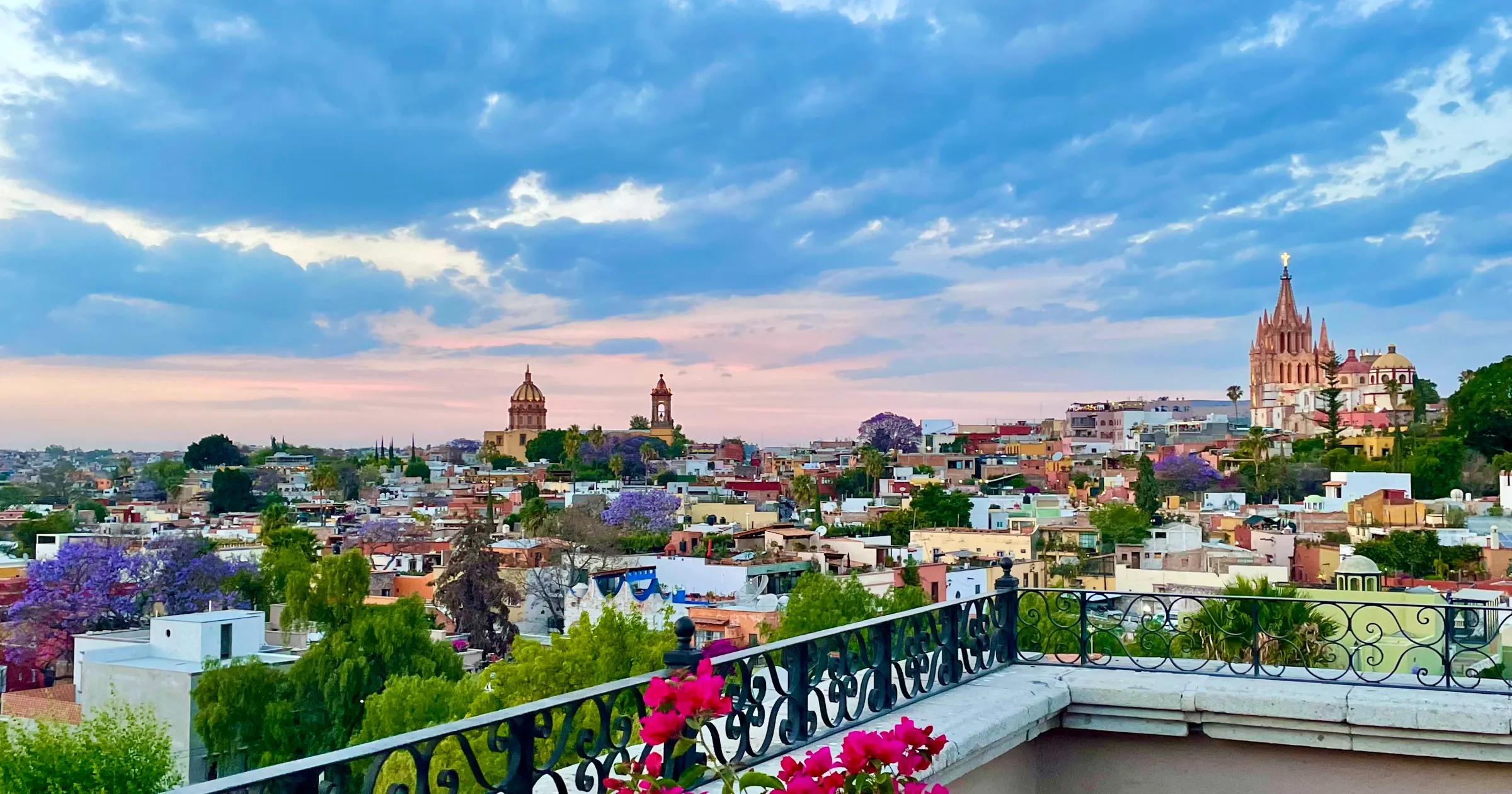 San Miguel de Allende Mexico images of skyline from the Rosewood hotel with a blue pink sky and the Parroquia de San Miguel Arcángel in the distance