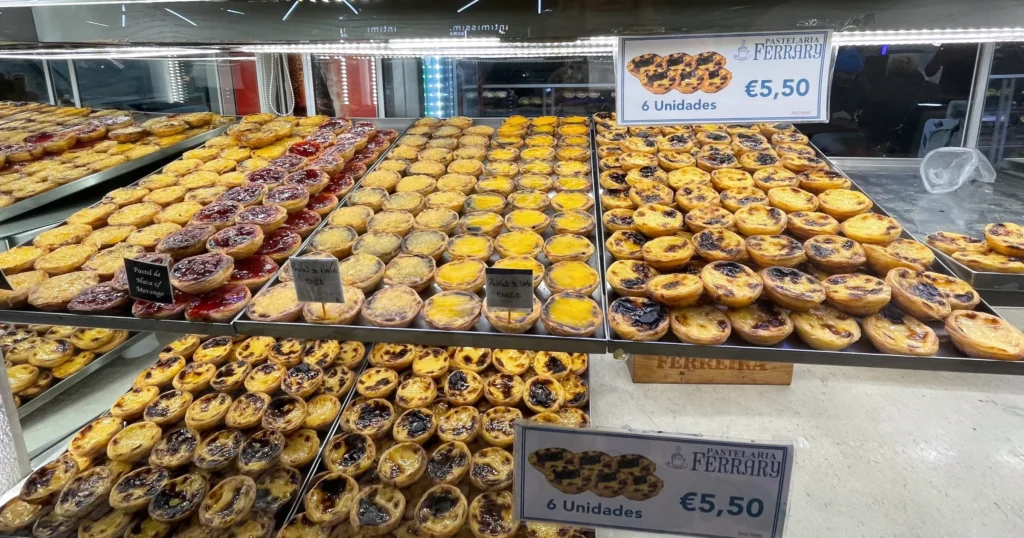 a shelf filled with Pastéis de Nata in a Lisbon bakery