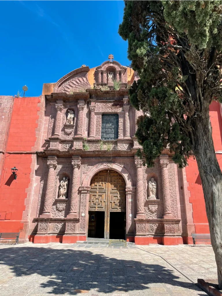 Plaza de Solidad red stone colored church with a curved stone entrance