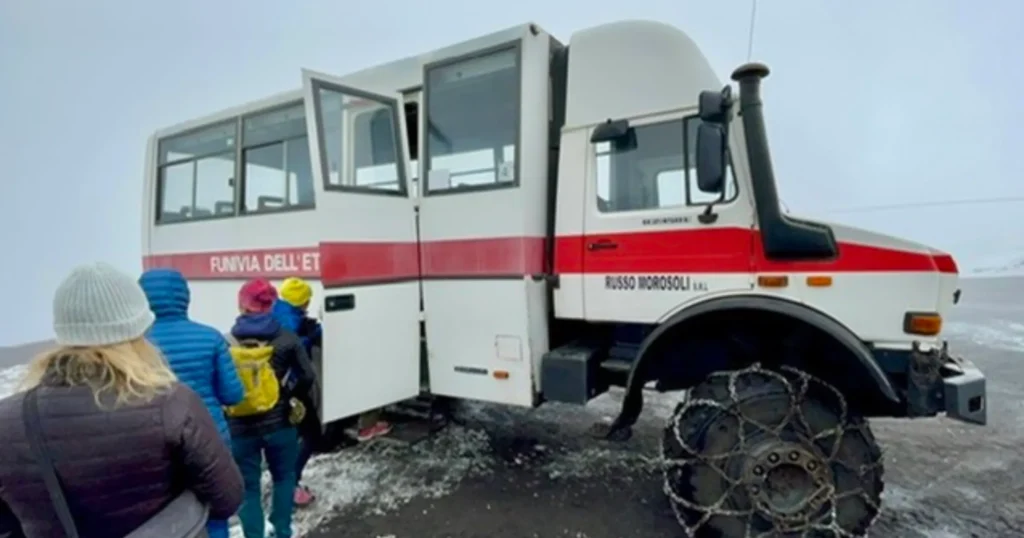 Image of white with a red stripe 4x4 truck used to bring passengers up to the crater of the Mount Etna Volcano in Sicily