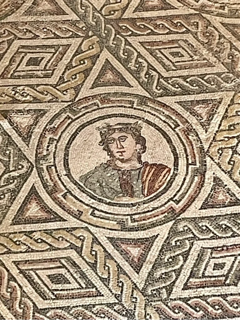 Multicolored roman mosaic tlle floor from the interior of the 4th century Villa Romana, a villa and estate