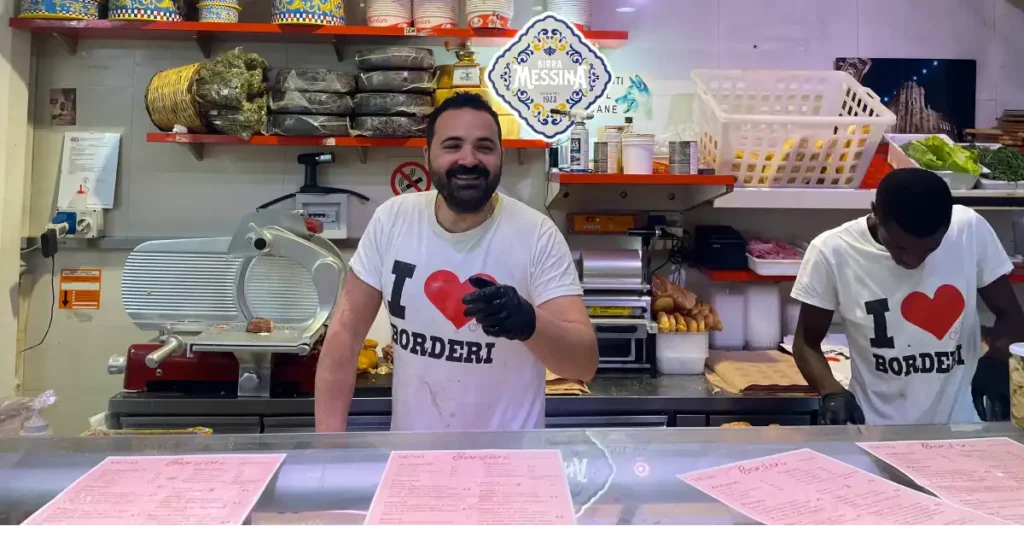 Man smiling and wearing a I love Morderi T-shirt