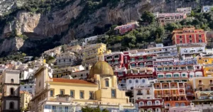Best Time To Visit Positano Feature Image Positano from the sea with the colorful buildings lining the mountain side