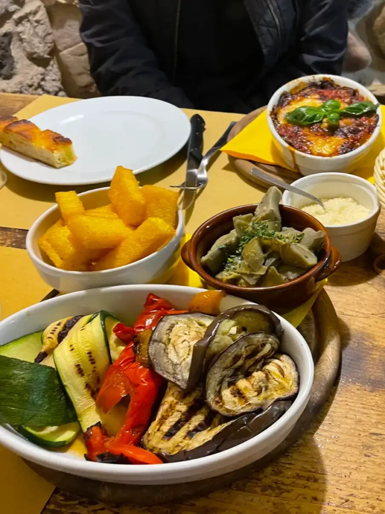 plates of friend polenta, grilled zucchini, artichokes and eggplant