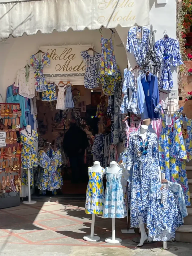 Mannequins at the entrance to a shop dressed in colorful linen outfits in Positano Italy