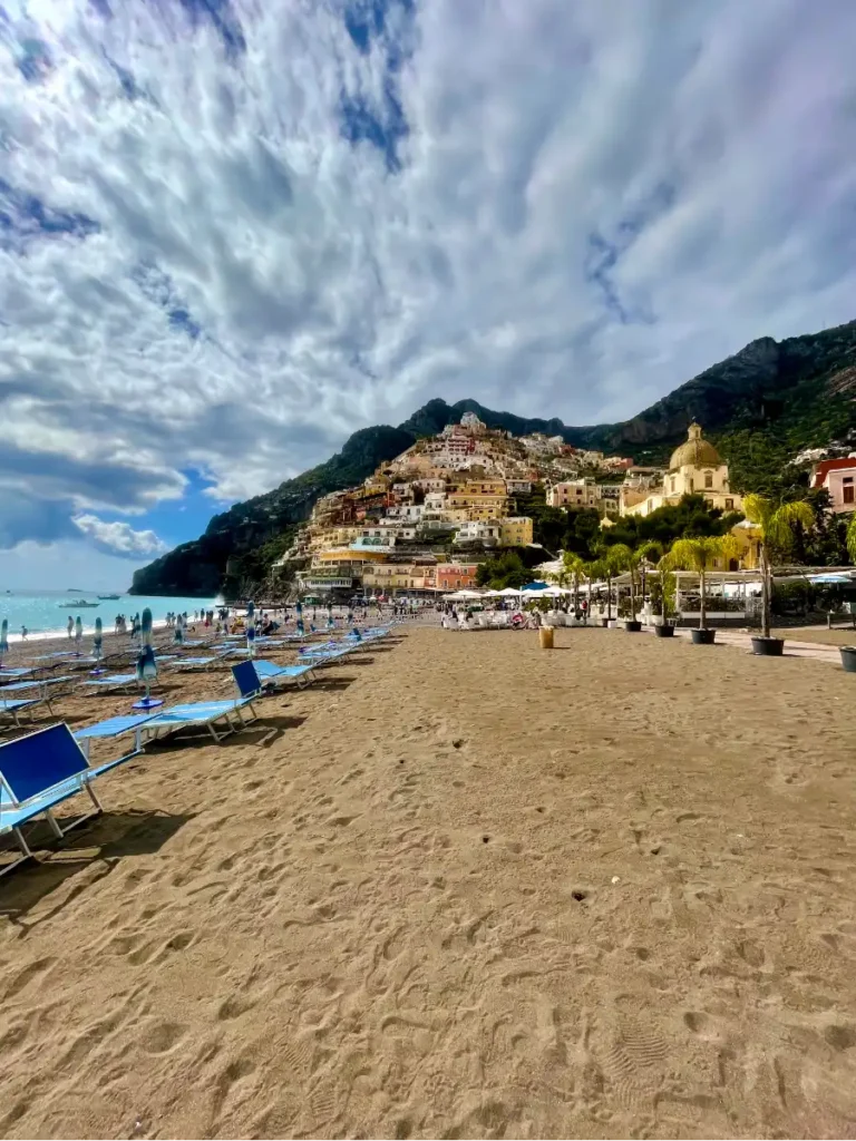 looking down Positano beach view with town going up the cliff in background