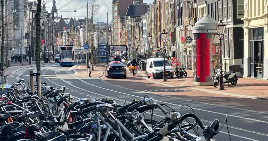 Amsterdam street with long line of parked bicycles