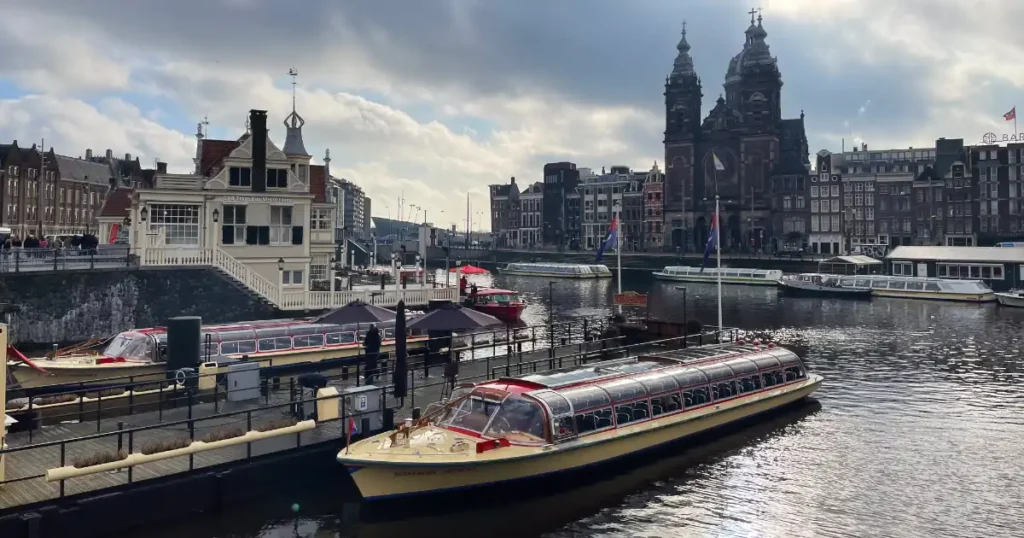 Red colored enclosed river boat cruise Amsterdam