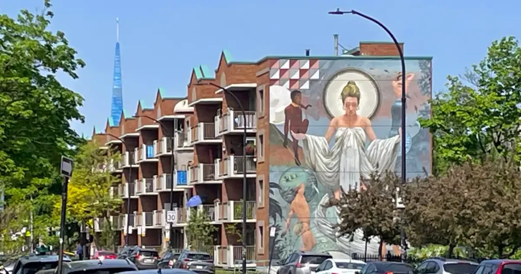 Apartment building with street art painted on the side