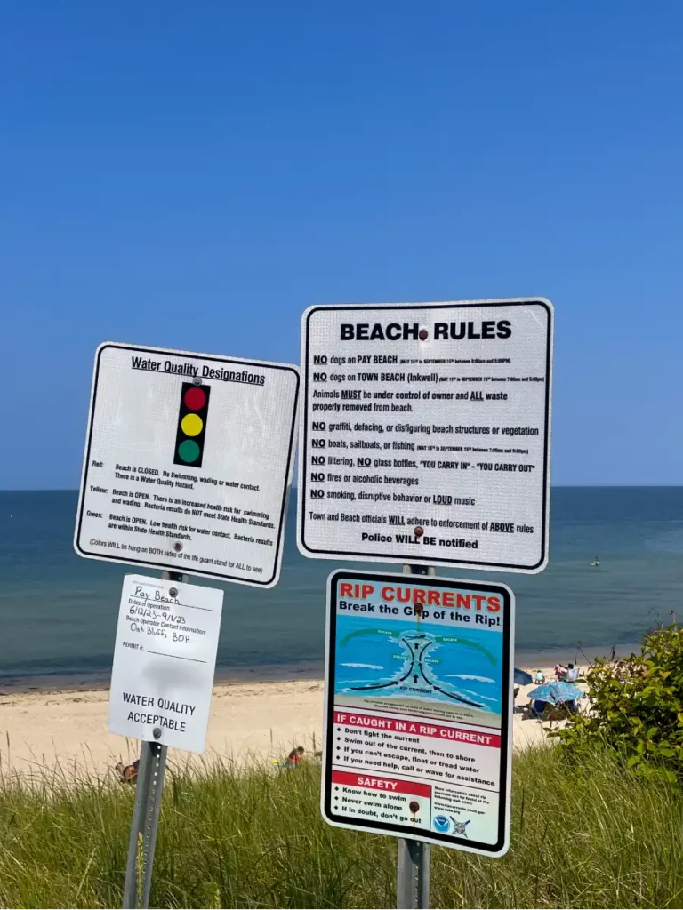 Multiple beach rule signs listing rules in English