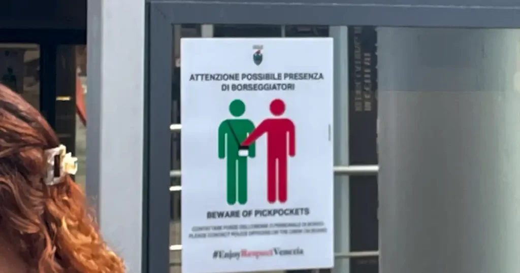 Beware of Pickpocket sign with red and green people icons