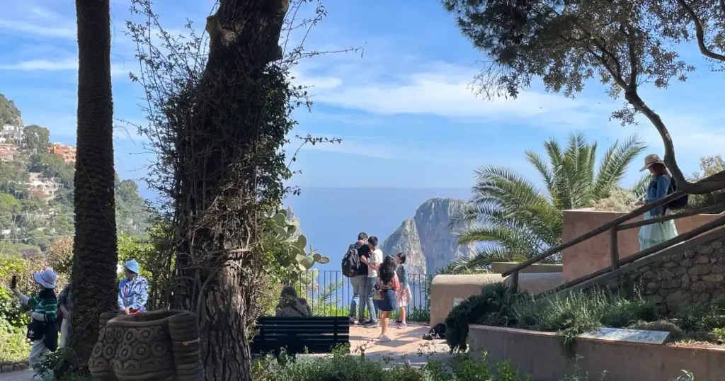 People standing in the Gardens of Augusta with view in the background