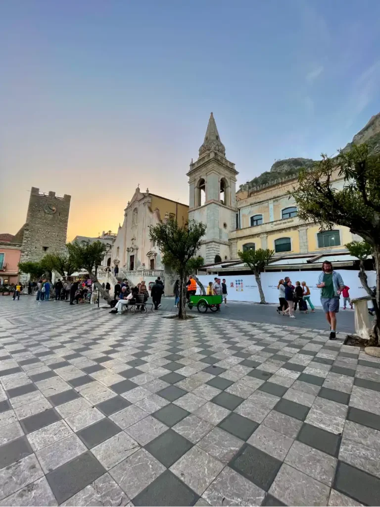 Taormina Duomo Square at sunset looking toward the church with the black and white diagonal tile pattern.