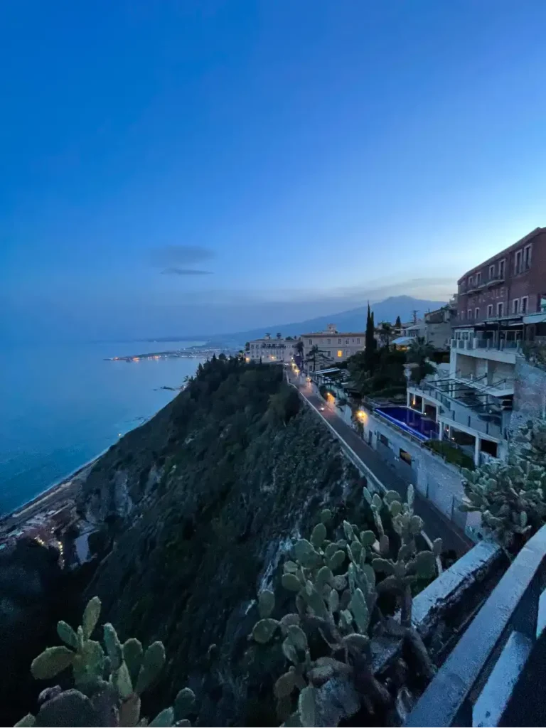 View of Taormina cliff side at dusk