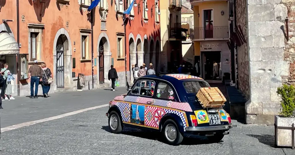 Taormina main square with colorful Italian car