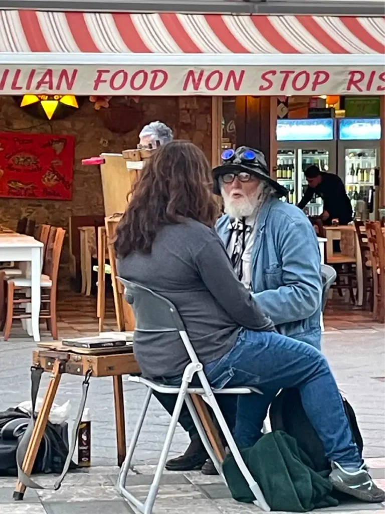 Man drawing street portraits in Taormina