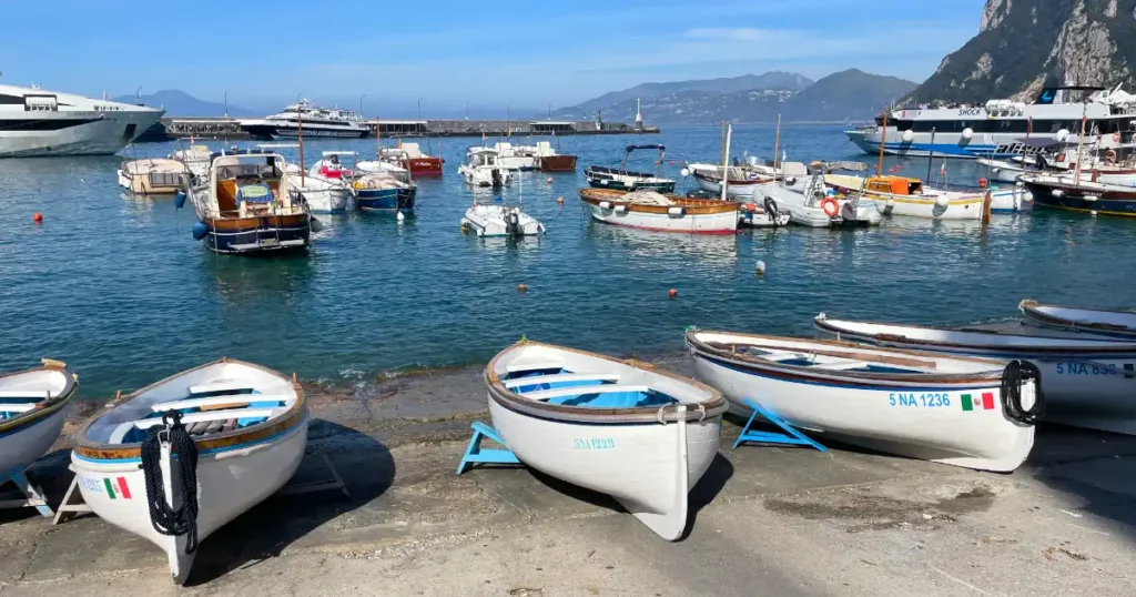 Three boats lined up on the shoreline in marina grande capri