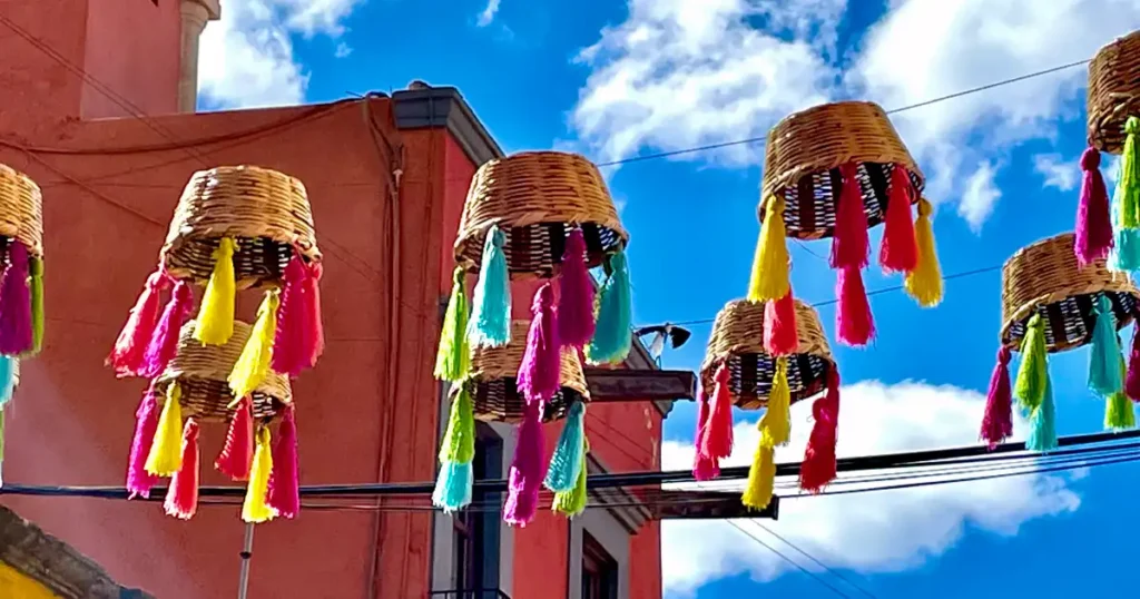 Mexican baskets with tassels hanging above the street