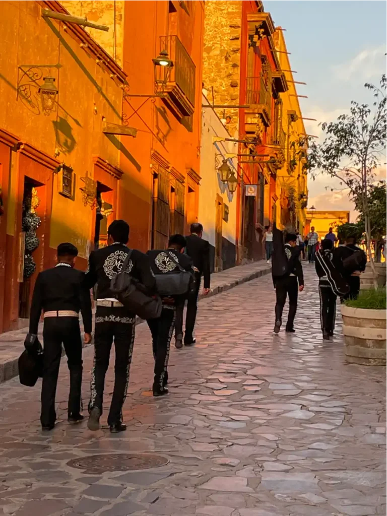 San miguel de allende mariachi band walking down the street at sunset