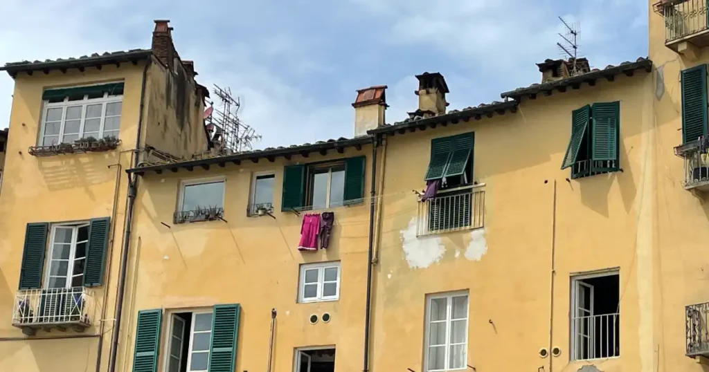 Slow Travel In Florence Day Trips Lucca Yellow Building