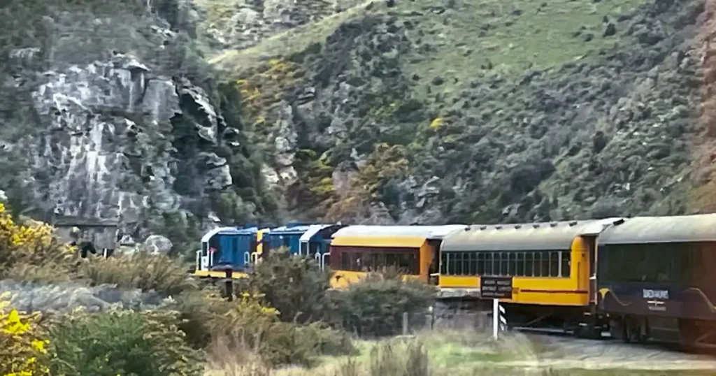 blue and yellow train heading down the tracks