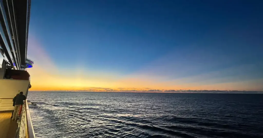 Sunset off of Cruise ship dark sky with yellow orange sun line