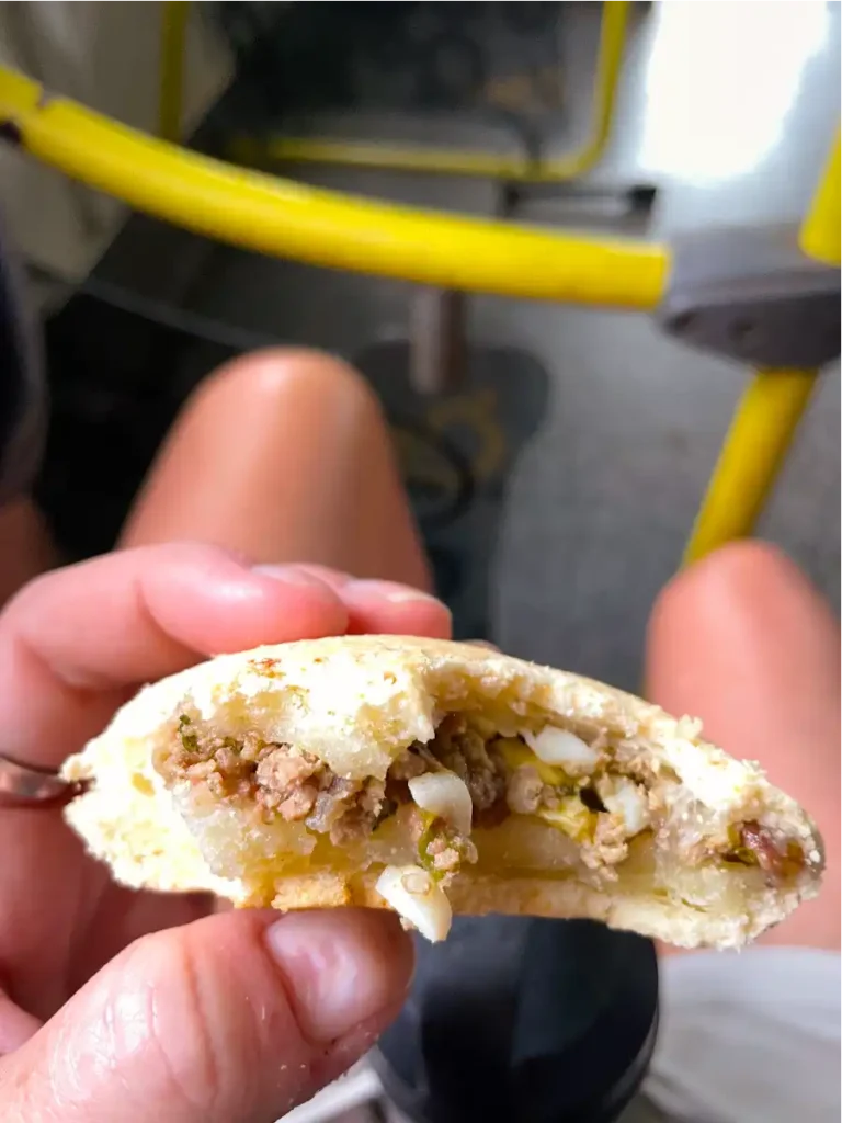 Half eaten Brazillian Cheese Bread on Bus