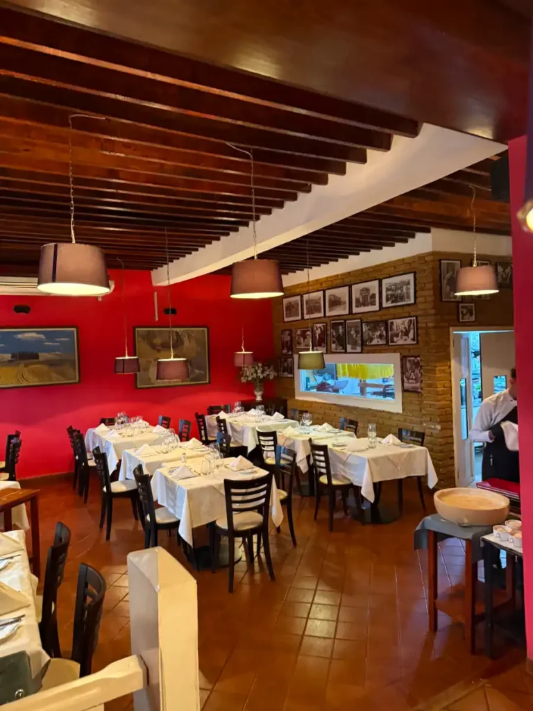 Tables at La Toscana on the Lower Level with View of Kitchen