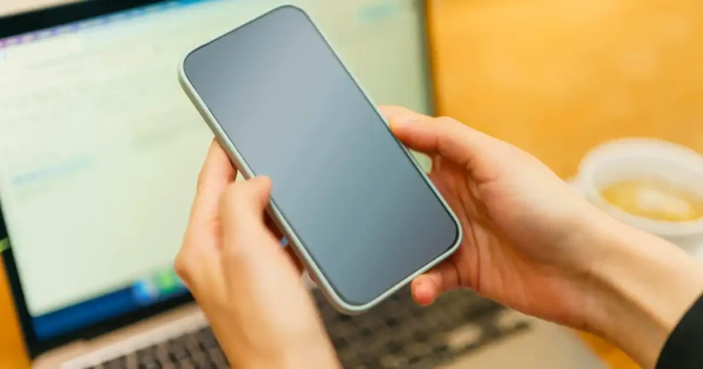 Connectivity at Sea computer and smartphone in hand