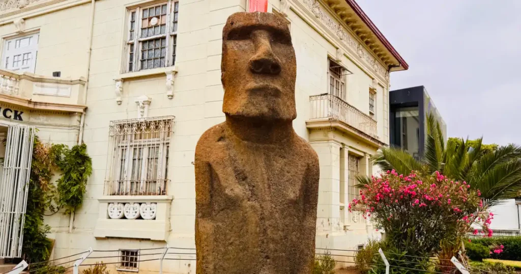 Easter Island Statue sitting outside the Fonck Museum in Chile on a cloudy day