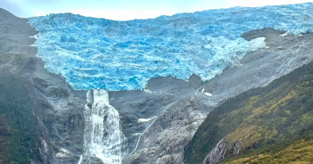 Glacier Italia while cruising through glacier alley chile with large waterfall