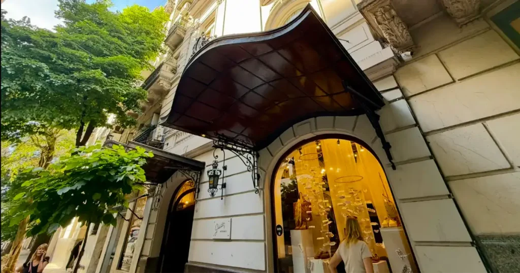 Guido shoe store with a woman looking at the display through the main window on a beautiful day