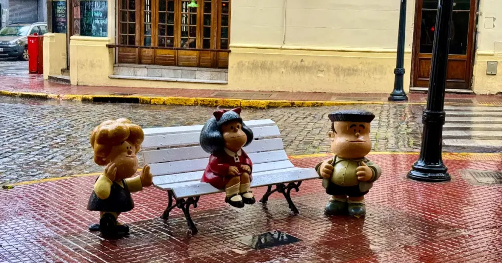 Malfalda and her friends are statues in the San Telmo neighborhood on rainy day 2024